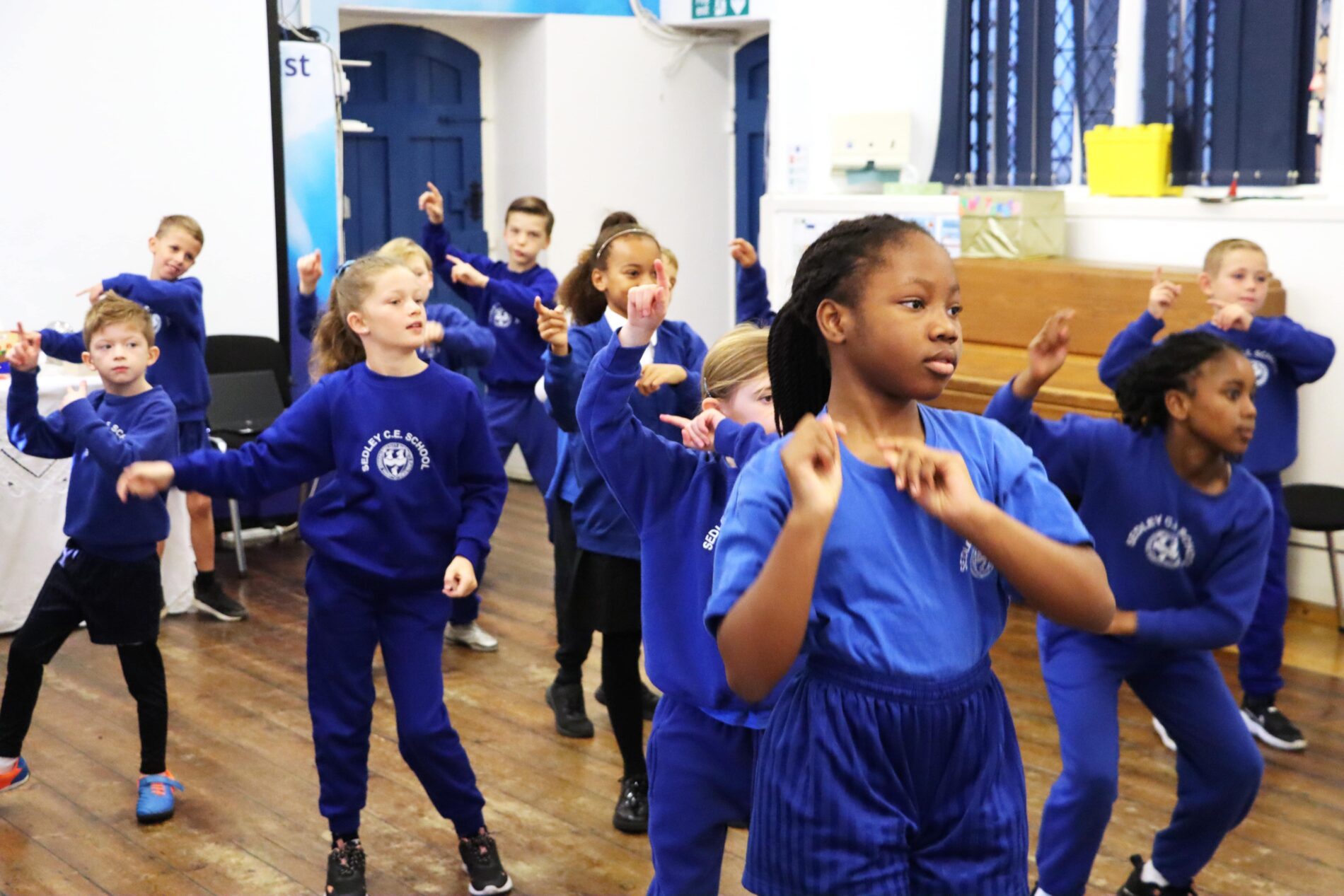 IMG_6110-min group of sedleys pupils dancing in the school hall