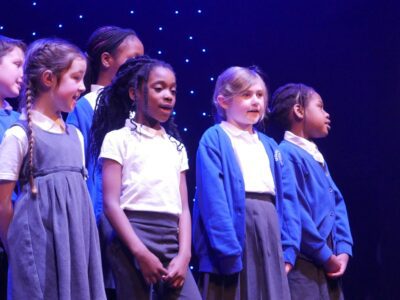 Sedleys primary school choir standing on stage at the Aletheia Academies Trust choir concert