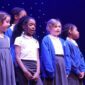 Sedleys primary school choir standing on stage at the Aletheia Academies Trust choir concert