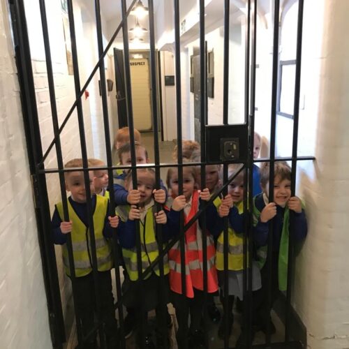 329052713_876879530074677_3370697809953949685_n Sedleys EYFS Class at the police station, standing behind bars