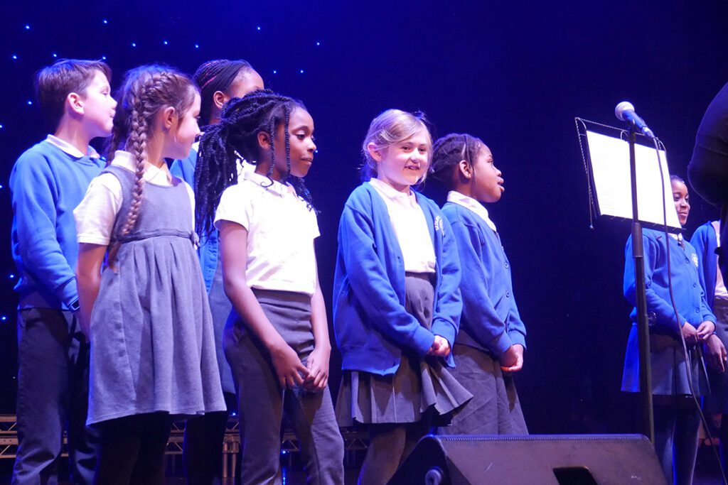 P1210973 Sedleys primary choir singing on stage at the aletheia trust choir concert